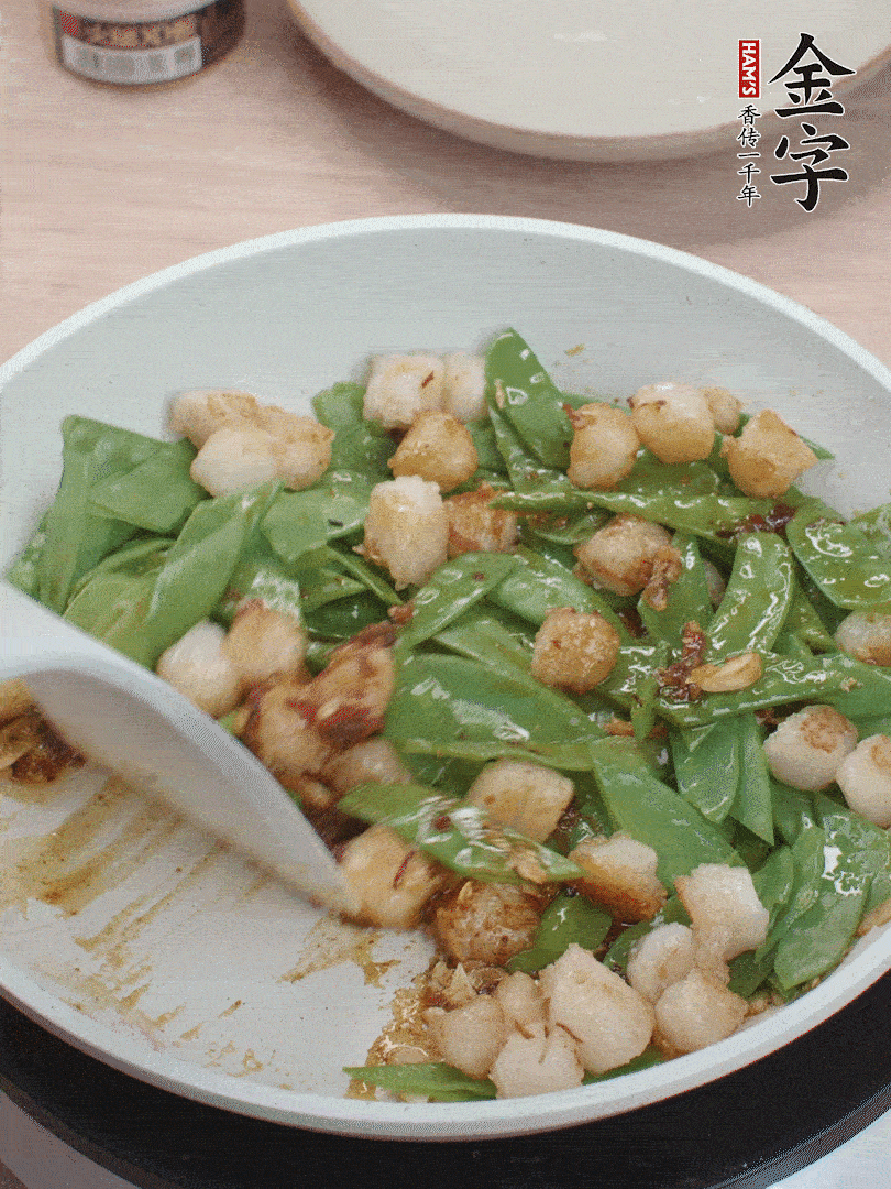 下甜豆莢、鮮貝輕輕翻炒均勻。